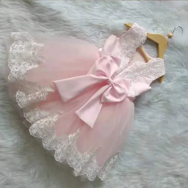 Light pink elegant baby girl party dress with lace details and large bow for infants