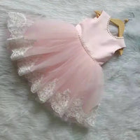 pink elegant baby girl party dress with pearl trim and lace hem for toddlers on hanger