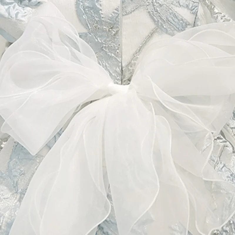 elegant little girls brocade dress in silver with large white bow accent for infants