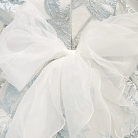 elegant little girls brocade dress in silver with large white bow accent for infants