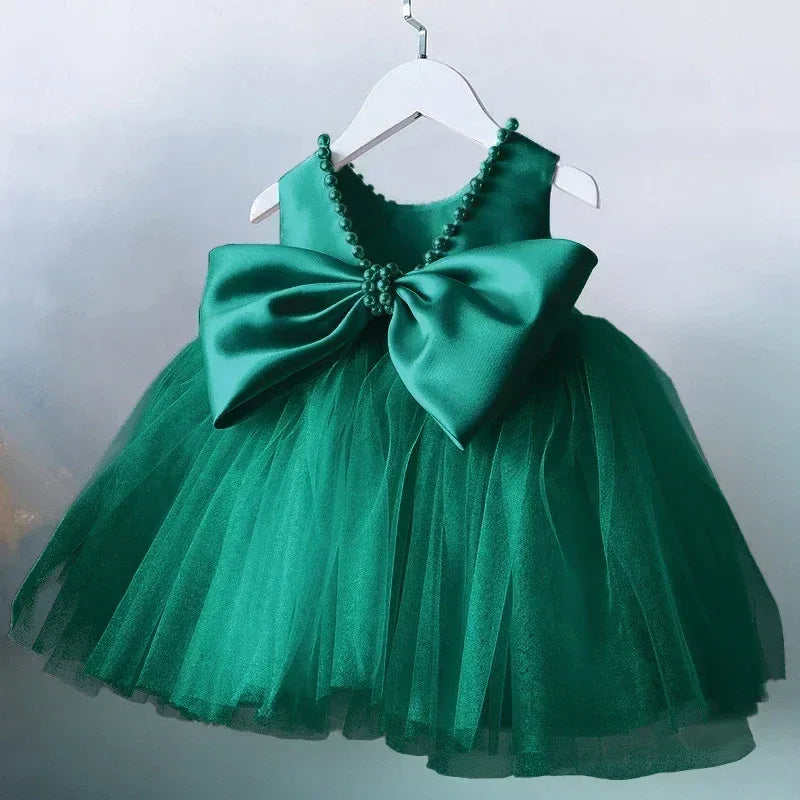 elegant V back dress for girls in emerald green tulle with large satin bow and pearl trim, toddler size
