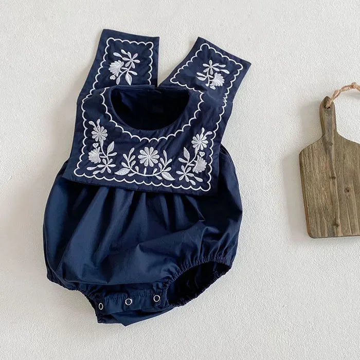 Navy blue embroidered baby romper with sailor collar for infants with white floral embroidery