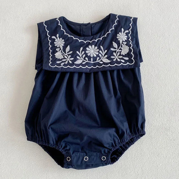 navy blue embroidered baby romper with sailor collar for infants with white floral embroidery