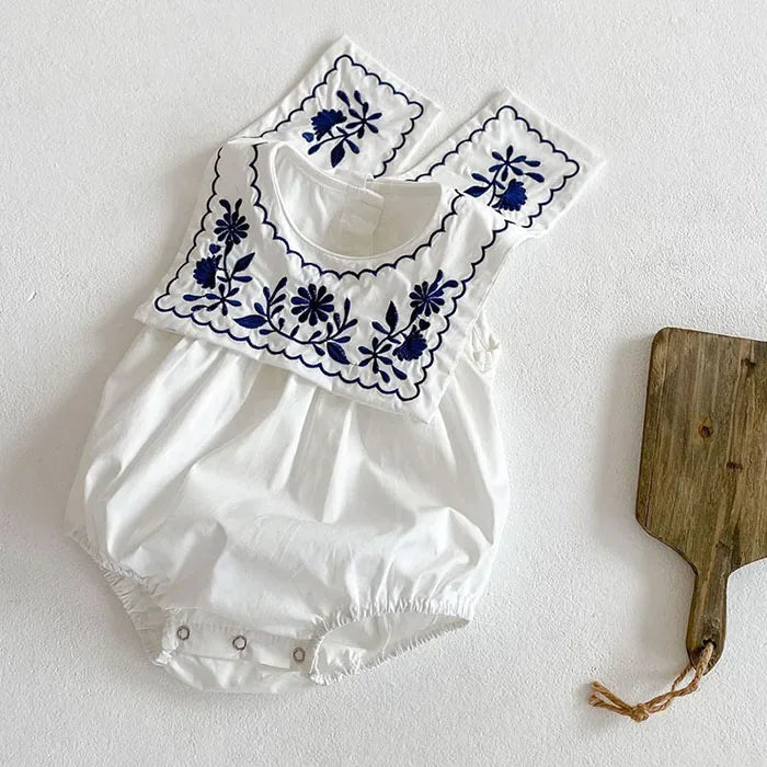 white embroidered baby romper with sailor collar and navy floral embroidery for infants