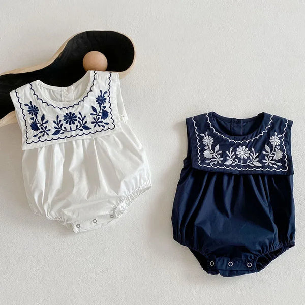 White and navy embroidered baby romper with sailor collar for infants featuring floral embroidery