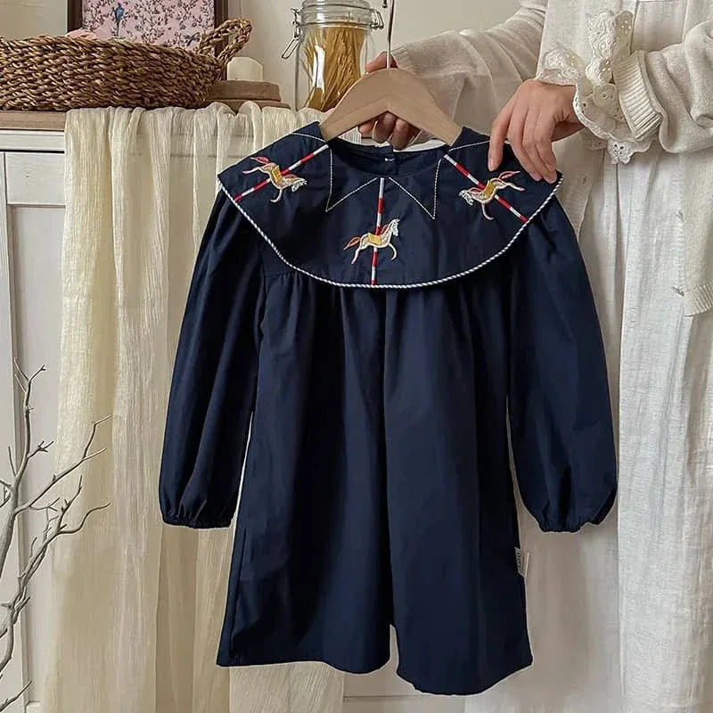 navy blue embroidered dress for little girls with long sleeves held on hanger for toddlers