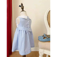 Toddler blue checkered sleeveless dress with white collar displayed on mannequin with blue shoes nearby