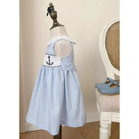 blue gingham embroidered girls party dress on toddler mannequin with anchor detail