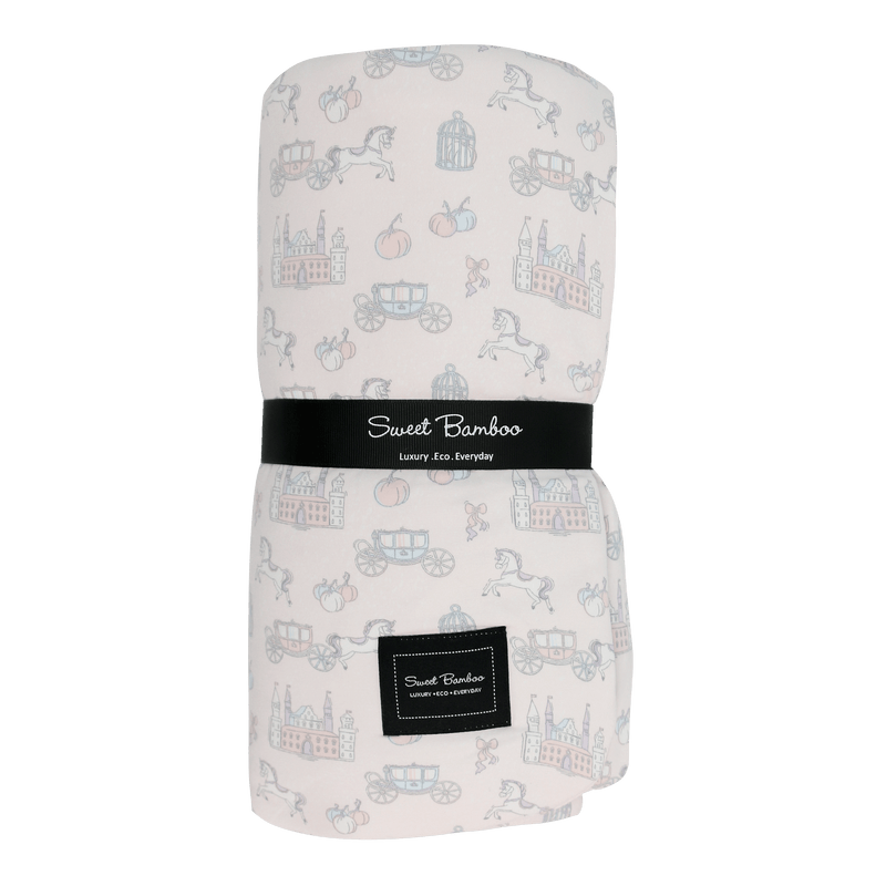 Fairy Godmother Cloud Blanket with pastel fairy-tale print featuring castles and carriages on pale fabric.
