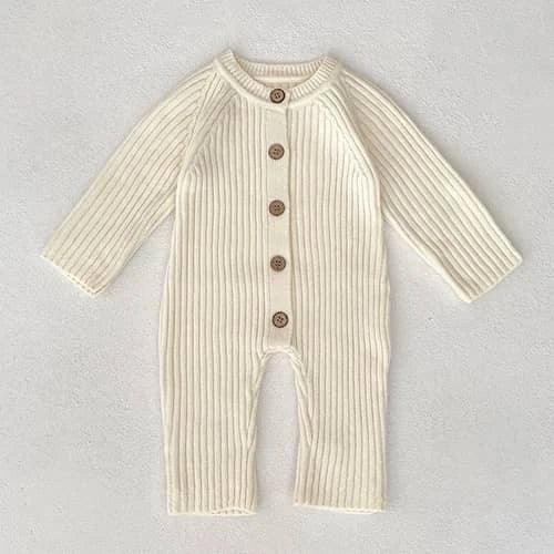 cream-colored fall knit baby romper for infants with long sleeves and wooden buttons