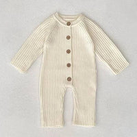 cream-colored fall knit baby romper for infants with long sleeves and wooden buttons