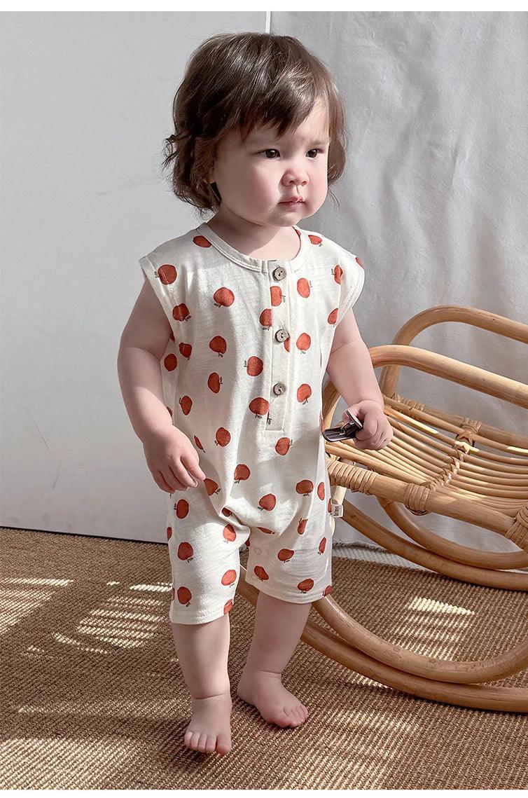 Cream and orange floral baby romper for toddlers with sleeveless design and button front