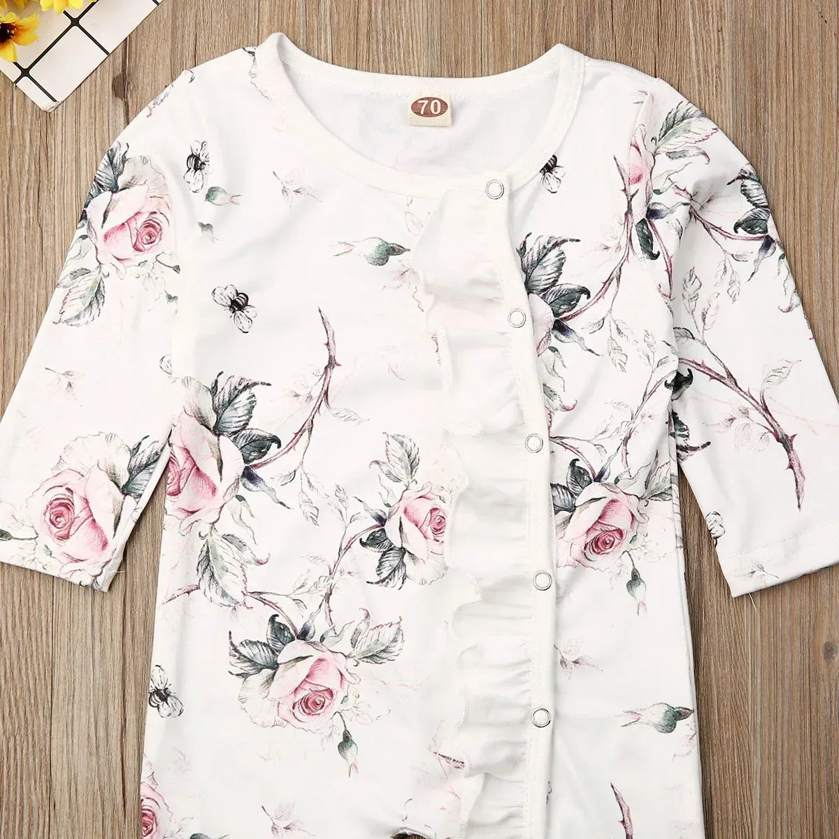 floral baby romper pink rose for infants with long sleeves and ruffle detail on front
