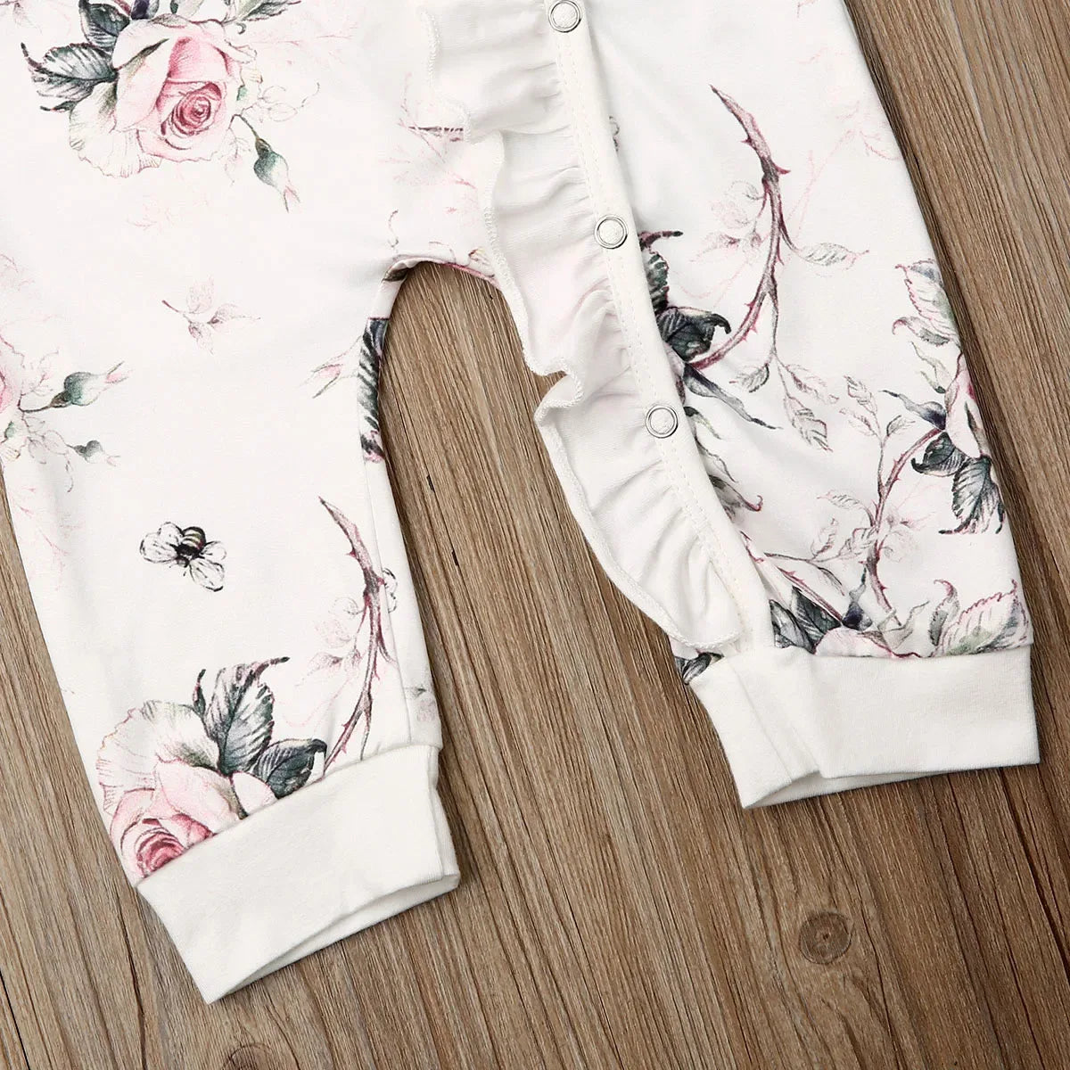 floral baby romper pink rose for infants with white background and snap buttons