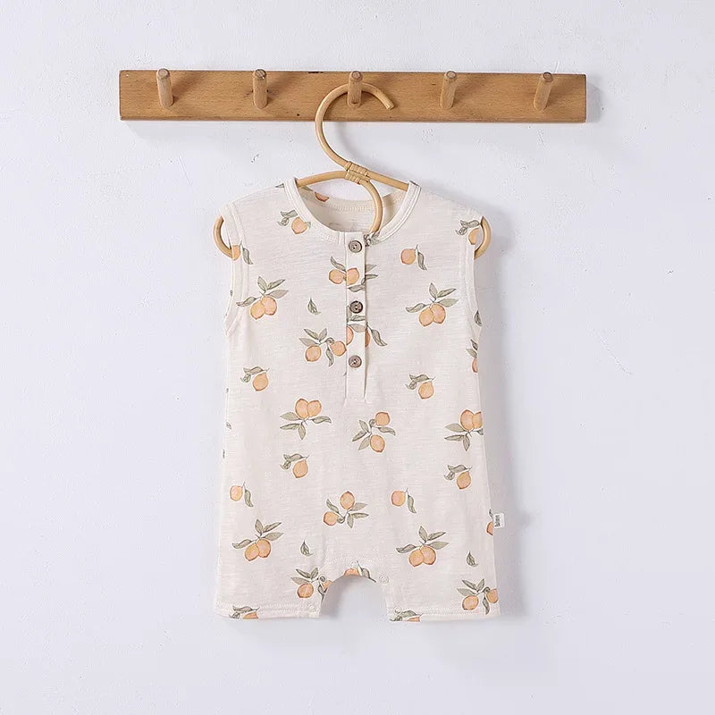 Cream sleeveless floral baby romper for infants with button-front and peach print design