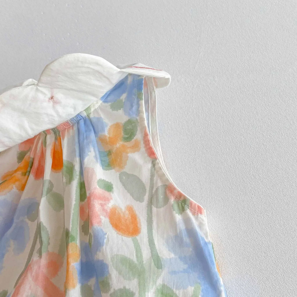 Floral baby romper with embroidered collar in pastel colors for infants