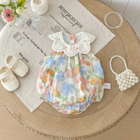 Floral baby romper with embroidered collar in pastel colors for infants with scalloped collar detail