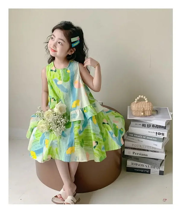 toddler girl wearing floral print baby dress in green blue and yellow with ruffle hem holding white flowers