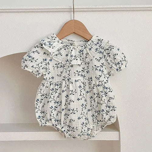 baby floral print romper in white with blue flowers, short sleeves, ruffled collar newborn to 12 months
