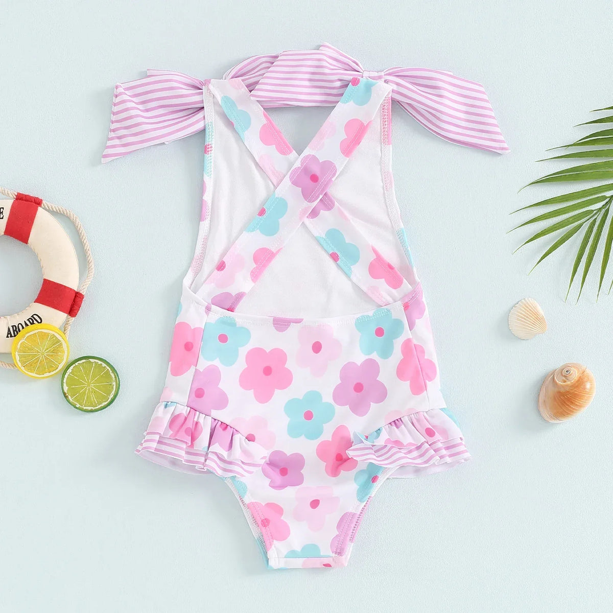 toddler floral print swimsuits for toddlers in pink blue and white with striped bow straps and ruffle details