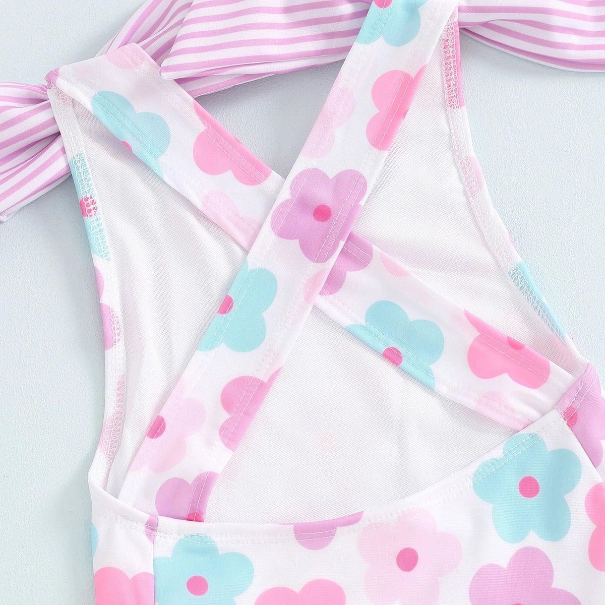 toddler floral print swimsuits for toddlers in pink blue and white with cross back straps