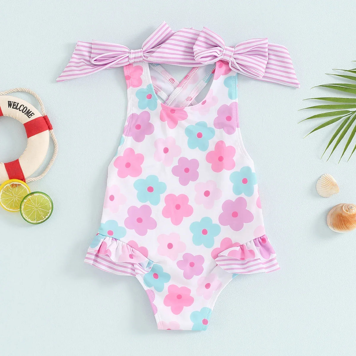 toddler floral print swimsuits for toddlers in pink blue and purple with striped bow straps and ruffle trim