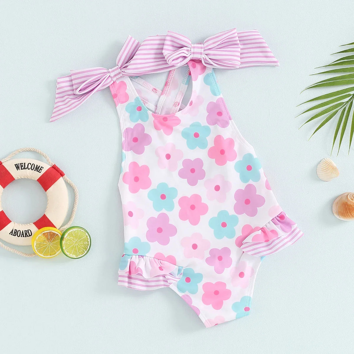 Toddler floral print swimsuits for toddlers in pastel pink blue with ruffle and striped bow details