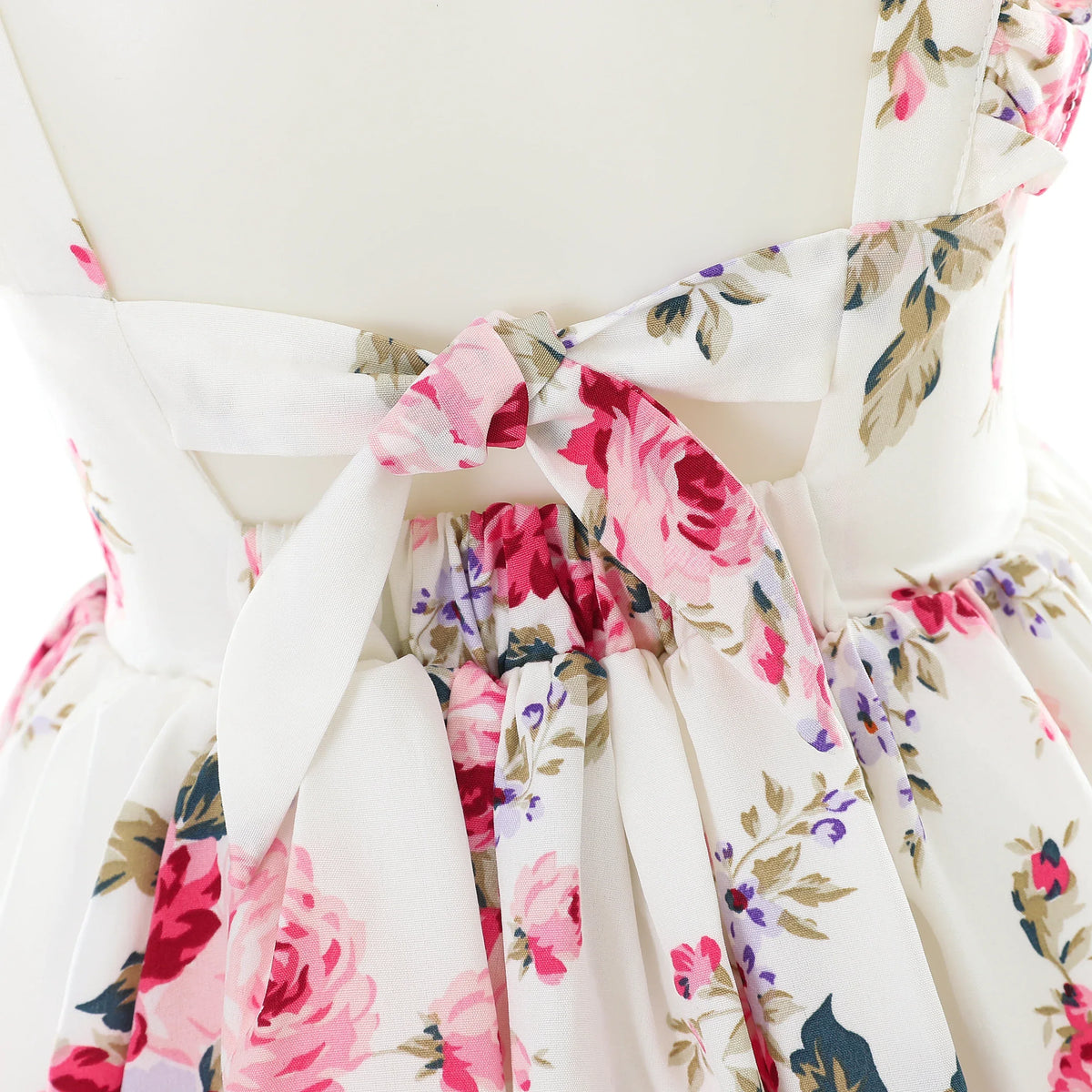 White floral summer dress for girls with pink and purple flowers and a tied back detail