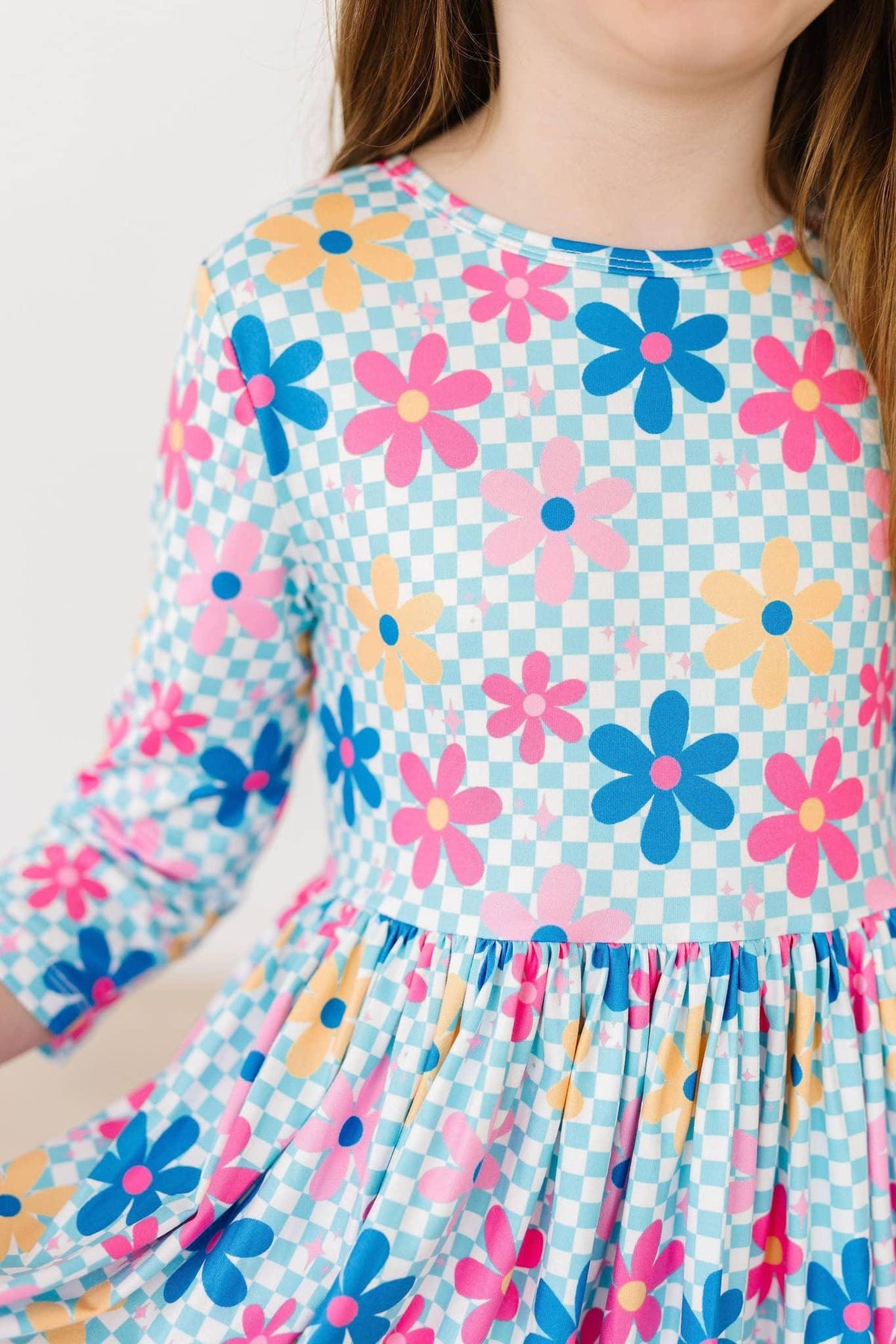 Girls blue twirl dress with 3/4 sleeves featuring colorful pink and yellow floral pattern