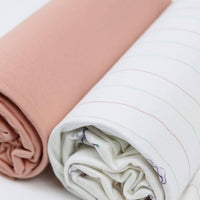 Rolled flower pink baby swaddle blankets for newborns showing soft fabric textures