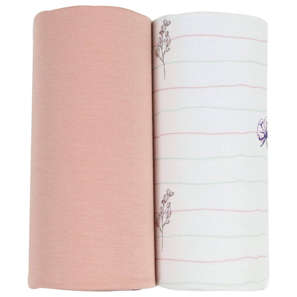 Two newborn baby swaddle blankets rolled up showing solid pink and white with flower pink baby swaddle blankets pattern
