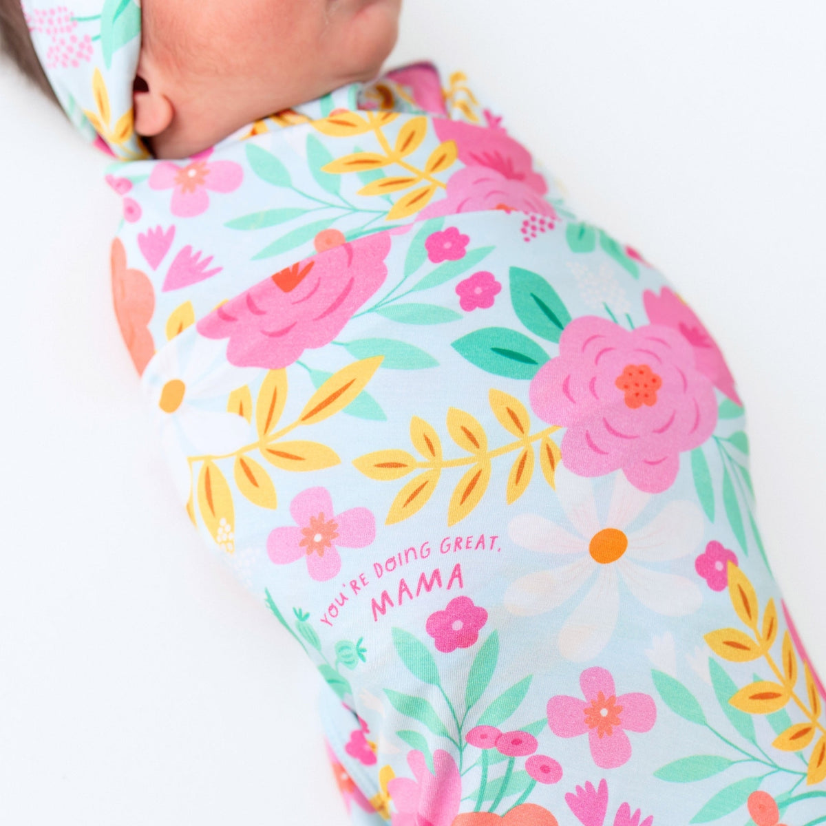 Baby Swaddle Wrap – Flower Power Soft Bamboo Blend draped over a stroller, highlighting its multi-use functionality.