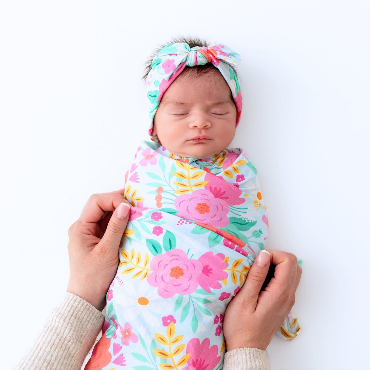 Baby Swaddle Wrap – Flower Power Soft Bamboo Blend being used as a nursing cover, demonstrating versatility for new moms.