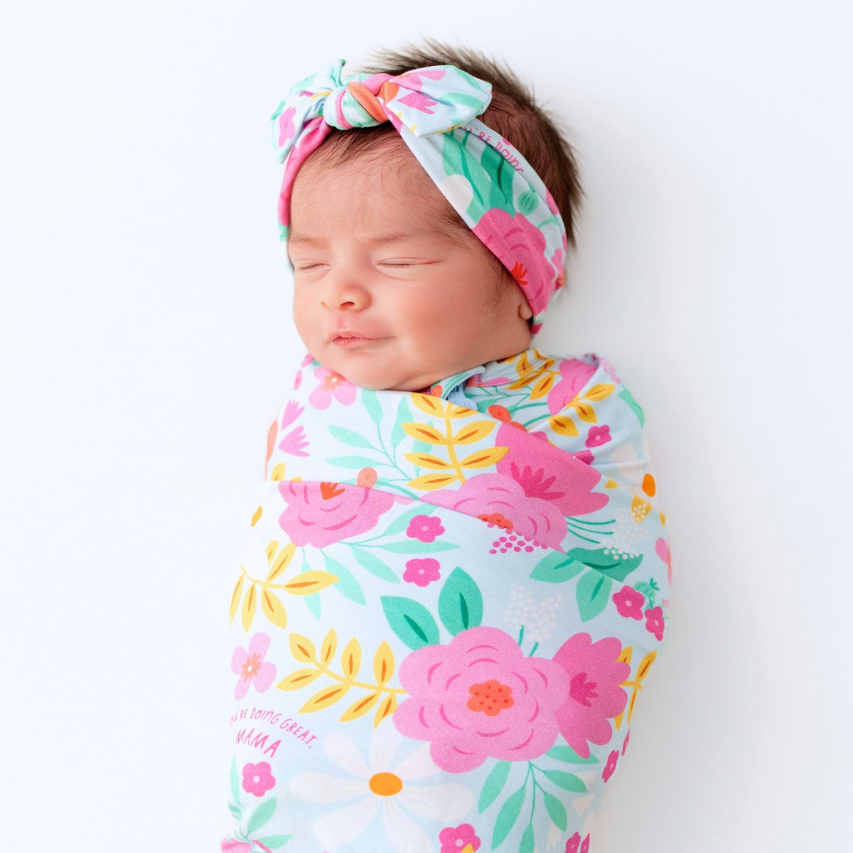 A baby peacefully sleeping in the Baby Swaddle Wrap – Flower Power Soft Bamboo Blend, illustrating its calming effect.