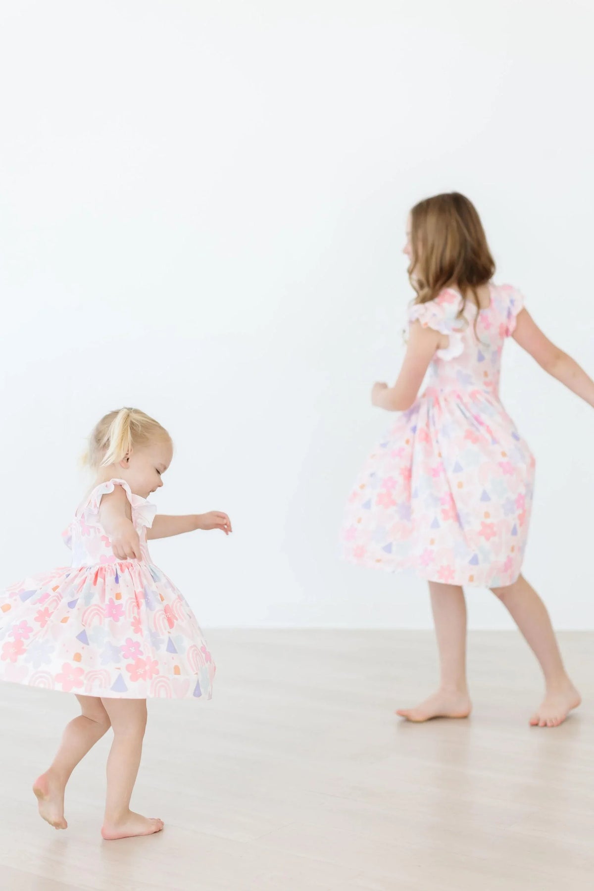 Girls pastel floral flutter sleeve twirl dress for girls in toddler and young sizes by Mila & Rose