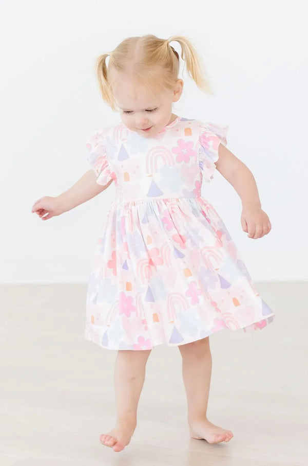 Toddler girl wearing pastel print flutter sleeve twirl dress for girls by Mila & Rose