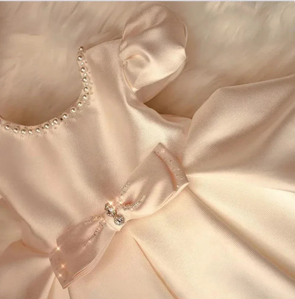 Ivory formal dress for babies and toddlers with pearl neckline and decorative bow detail