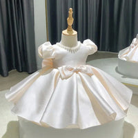 babies white formal dress with puff sleeves and bow detail for special occasions