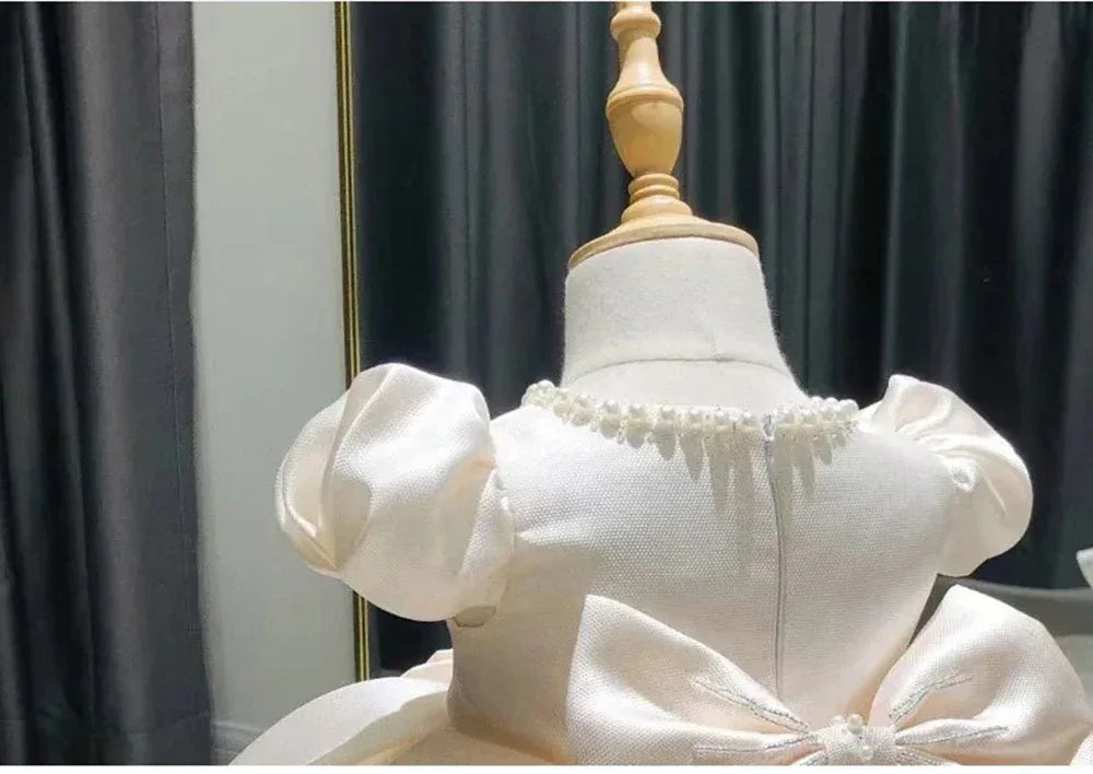Baby cream formal dress with puff sleeves and pearl neckline detail for toddlers