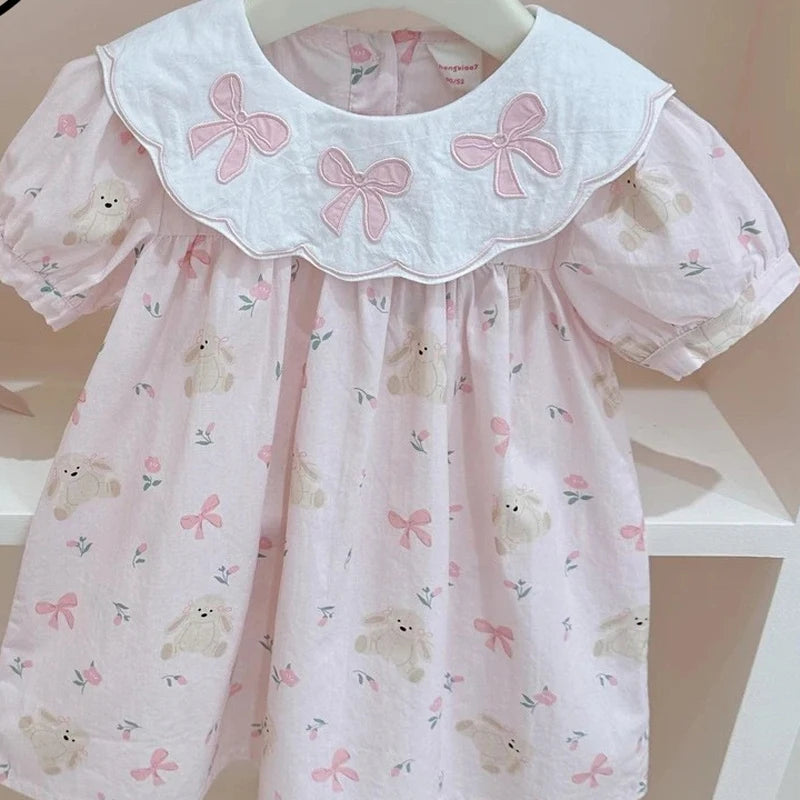pink girls a-line flower dress with white collar and bow details for baby toddlers