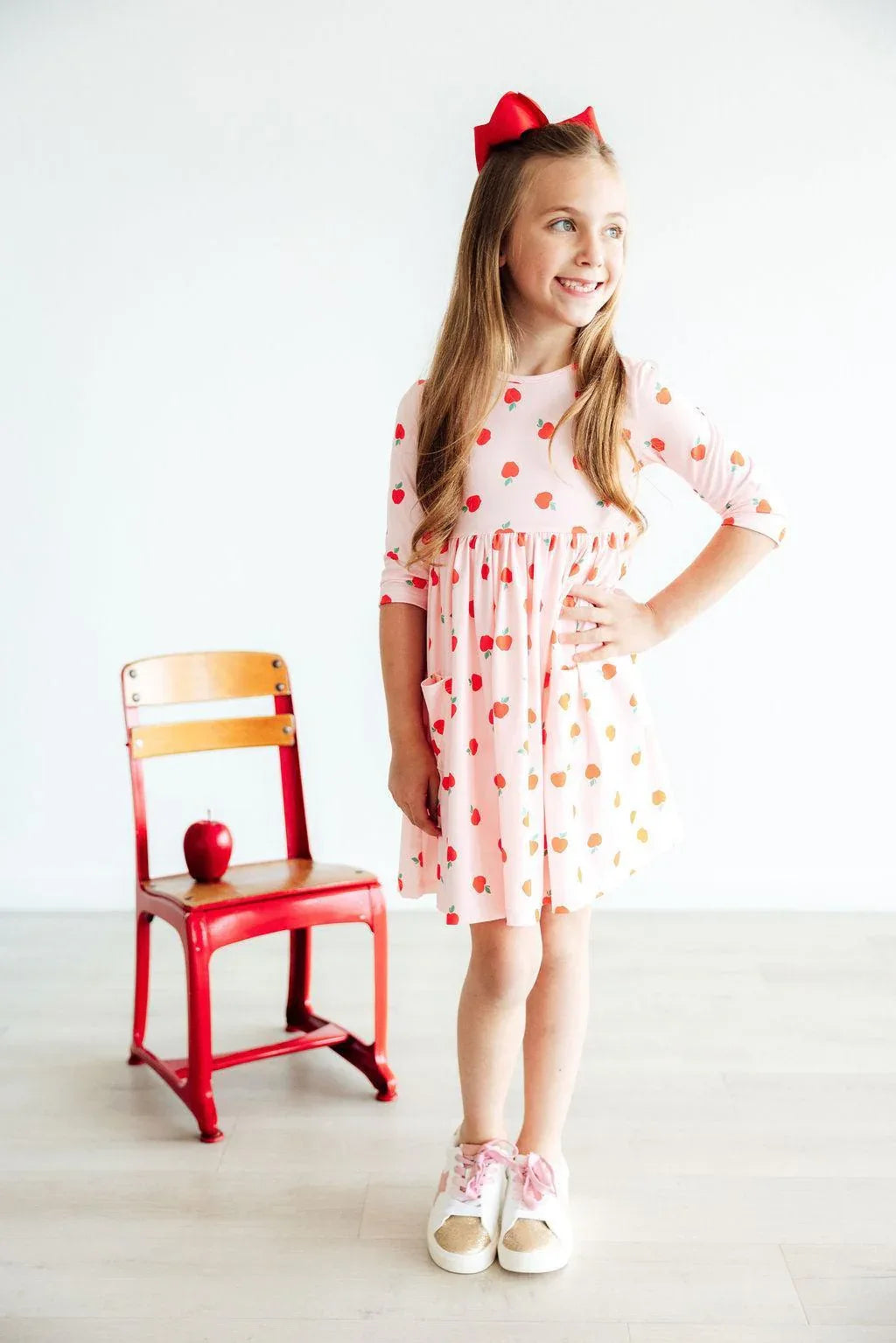 Girls apple print twirl dress by Mila and Rose in pink with  sleeves and pocket detail for kids