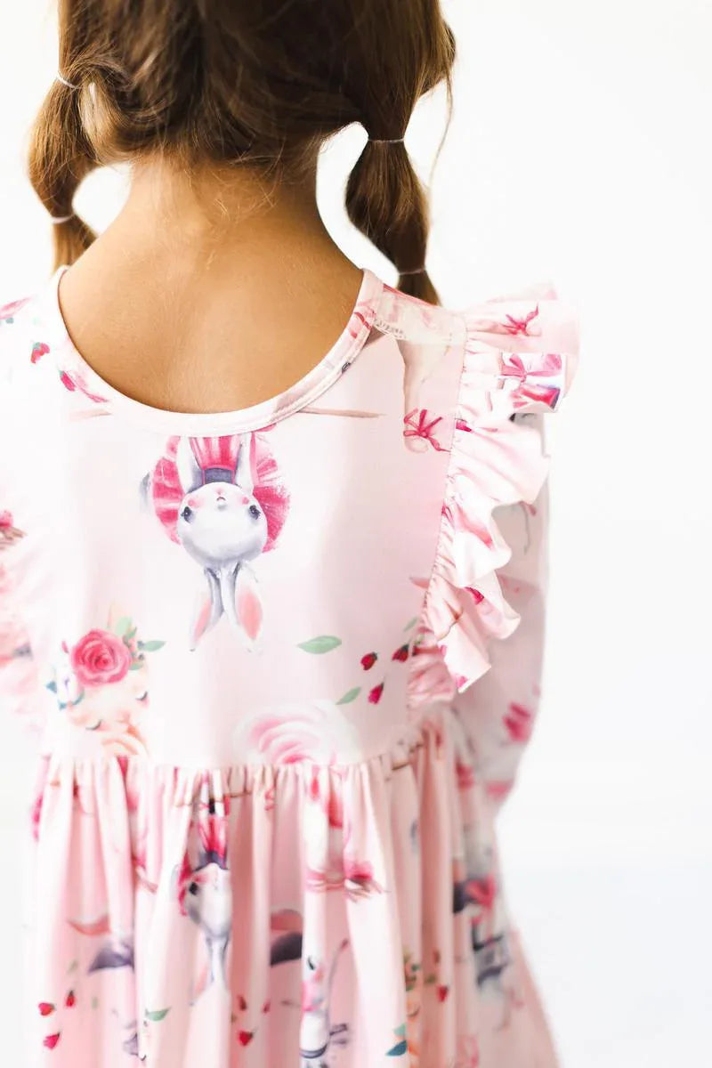Girls pink ballet twirl dress with floral and bunny print and ruffle detail on shoulder