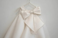 Girls white beaded occasion dress with large pearl-trimmed bow, toddler size
