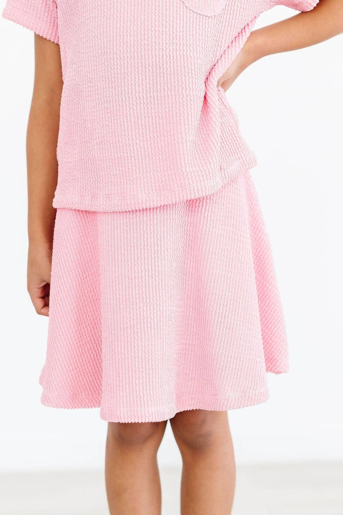 Girl wearing girls bubblegum pink twirl skort by Mila & Rose standing with hand on hip