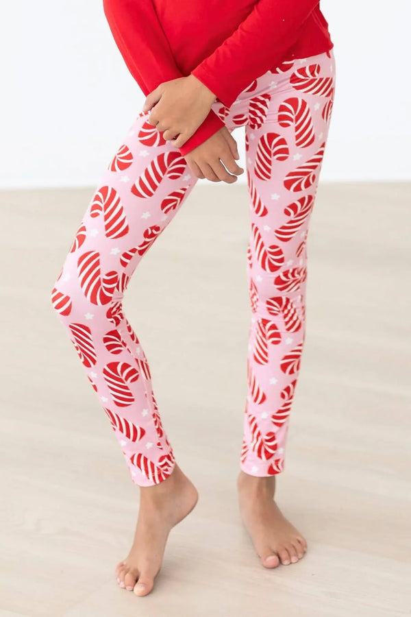 Girls candy cane leggings in white and red festive print, perfect holiday wear for kids