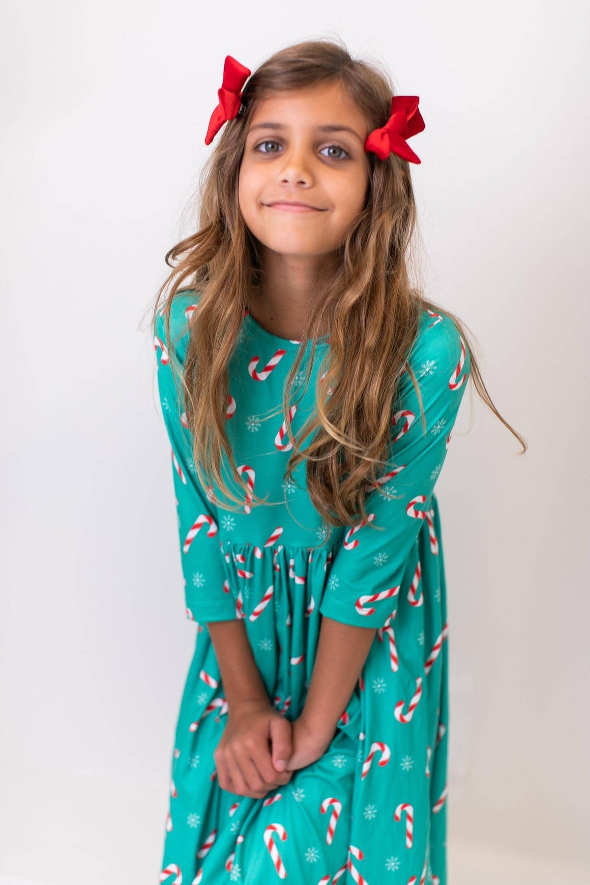 Girls Christmas candy twirl dress in green with candy cane print and 3/4 sleeves for kids