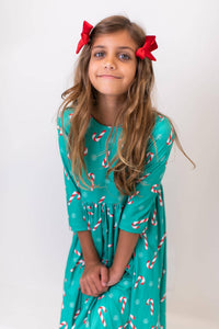 Girls Christmas candy twirl dress in green with candy cane print and 3/4 sleeves for kids