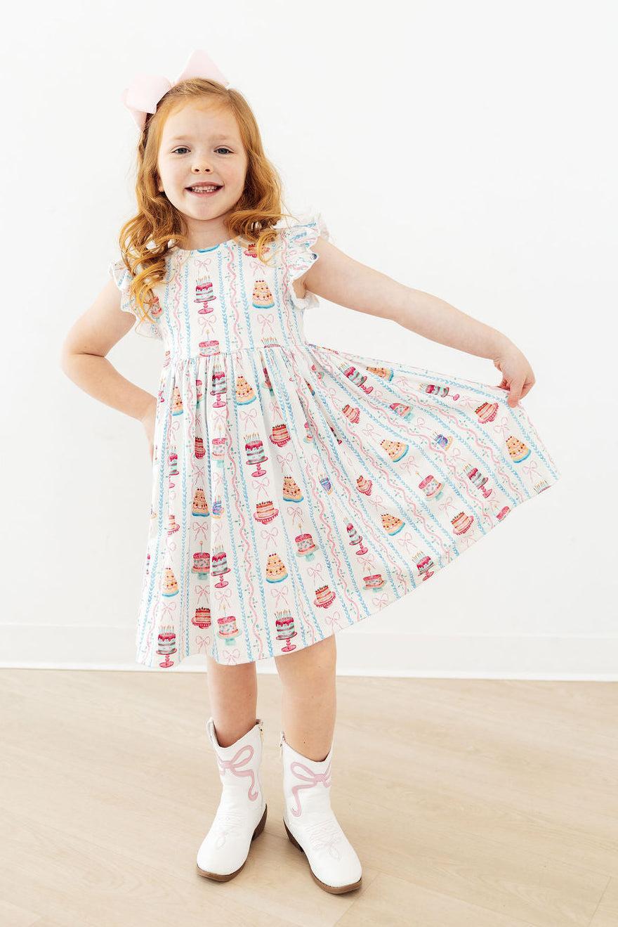 Girls white twirl dress for birthday with colorful dessert print and flutter sleeves