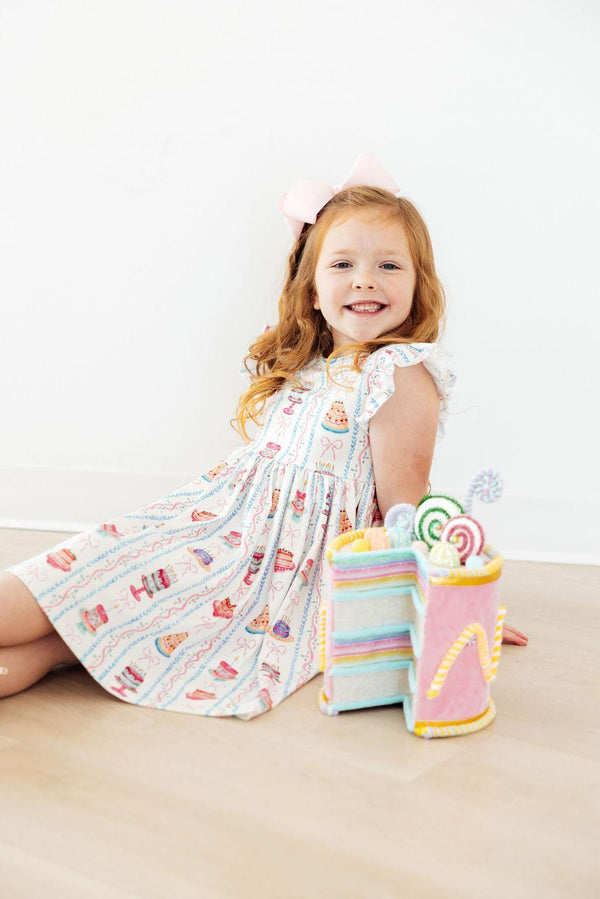 Girls white twirl dress for birthday with colorful candy print and flutter sleeves, size toddler