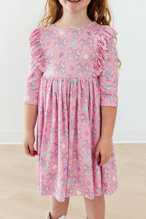 Girls pink twirl ruffle dress with 3/4 sleeves and colorful bow print by Mila & Rose
